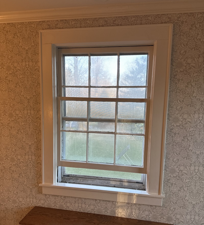 Old double hung window with flat trim and backband